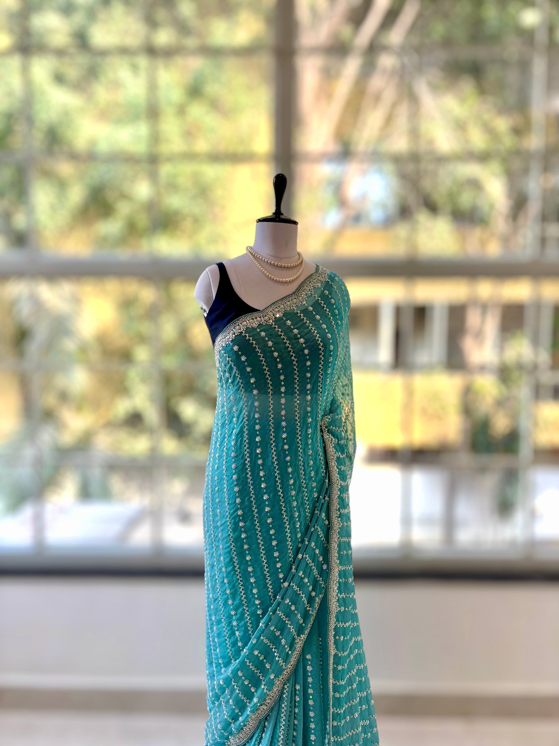 Powder blue shimmer chiffon embellished saree