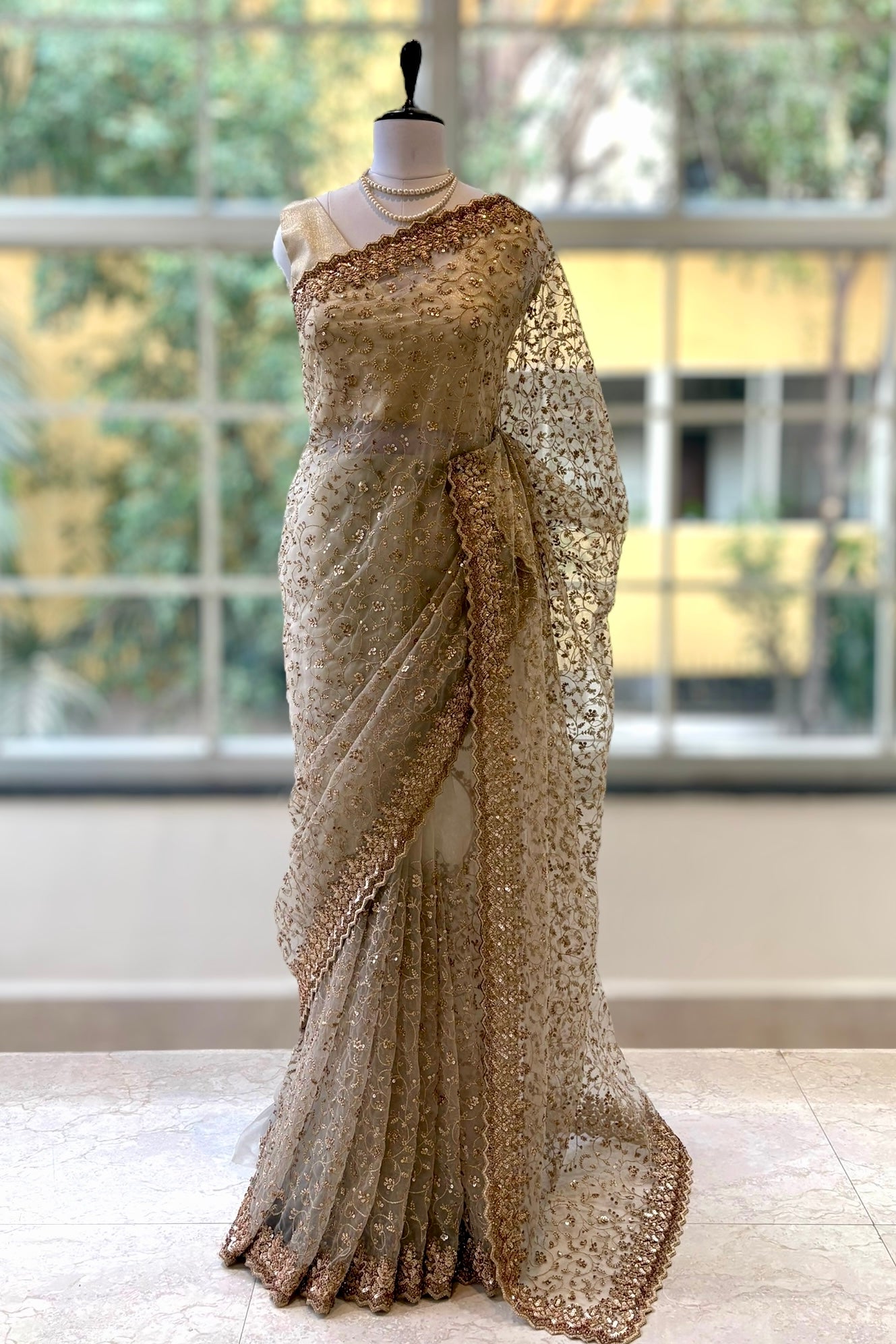 Golden sequins embellished net saree
