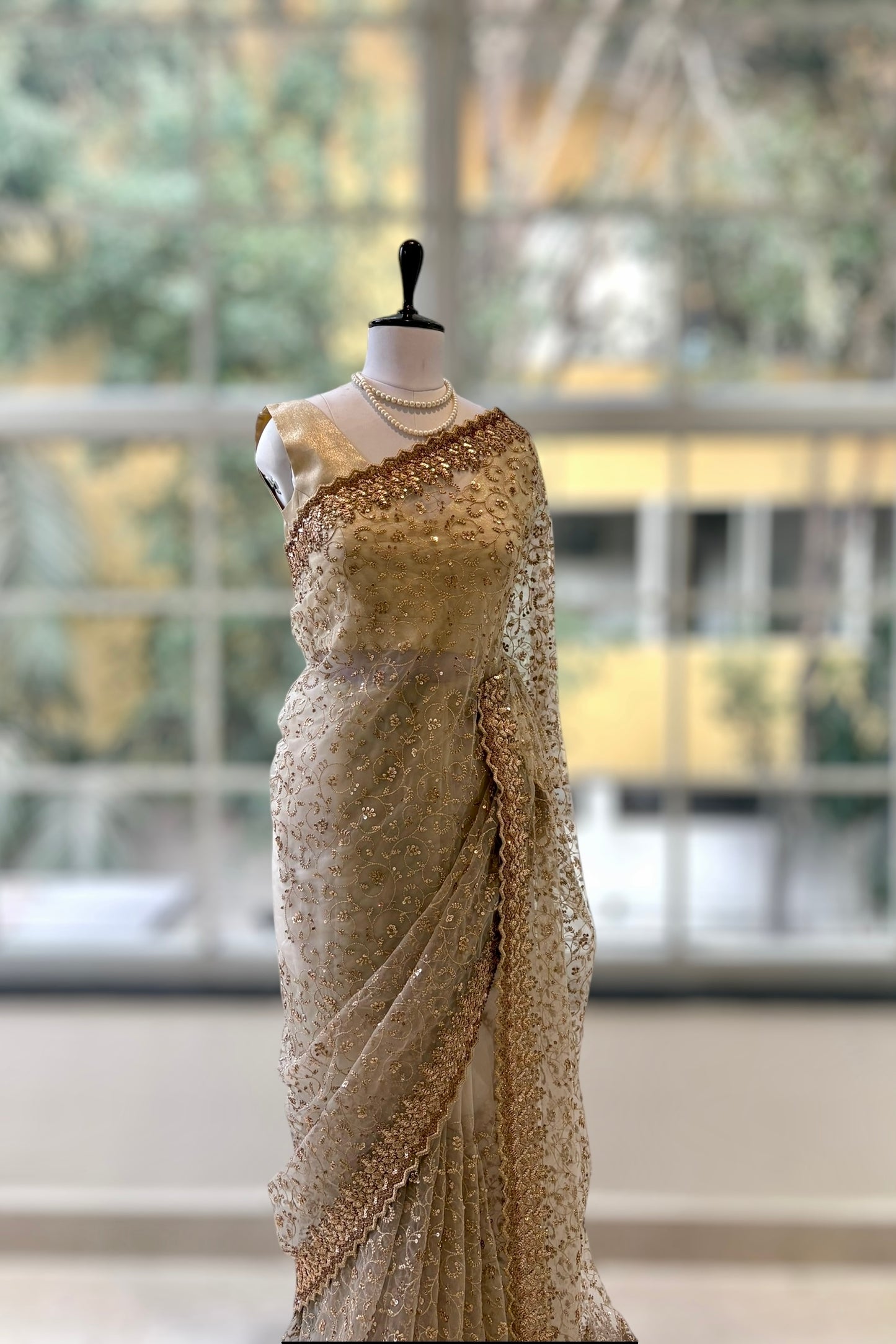 Golden sequins embellished net saree